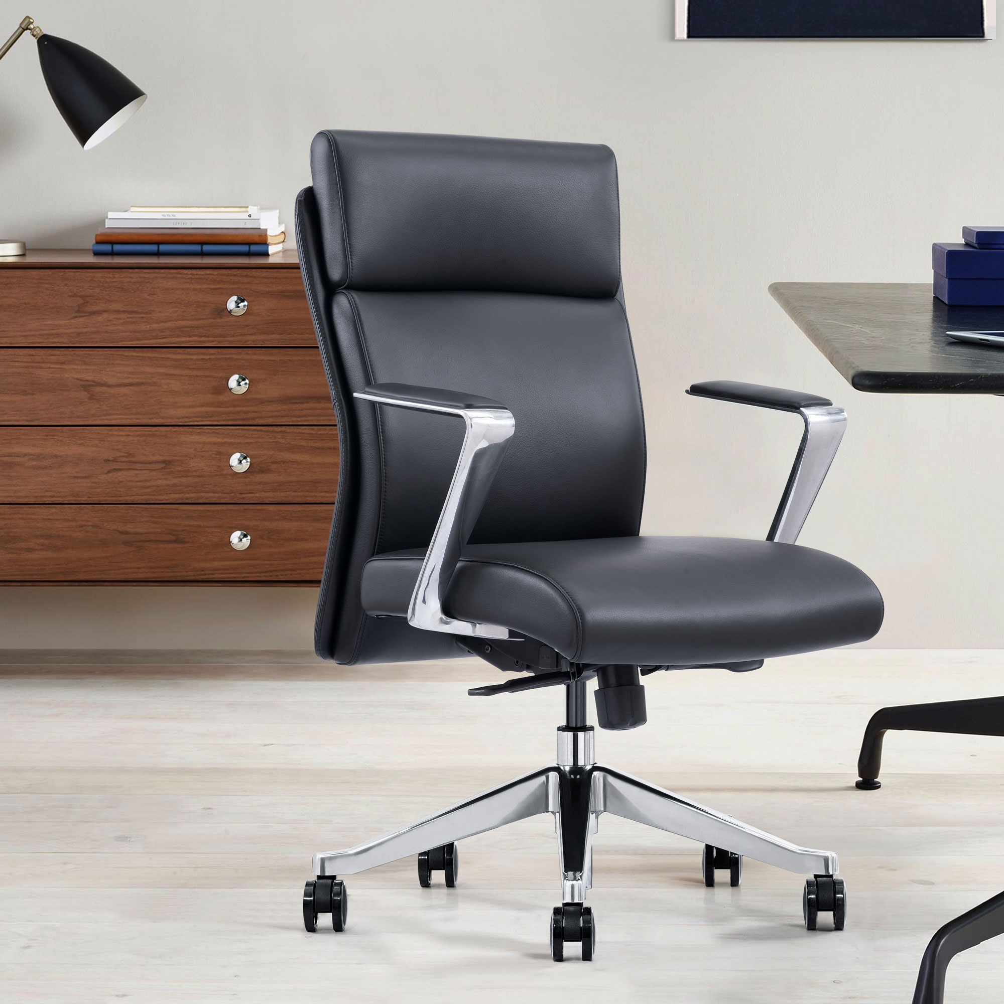 Black leather desk chair with arms and wheels